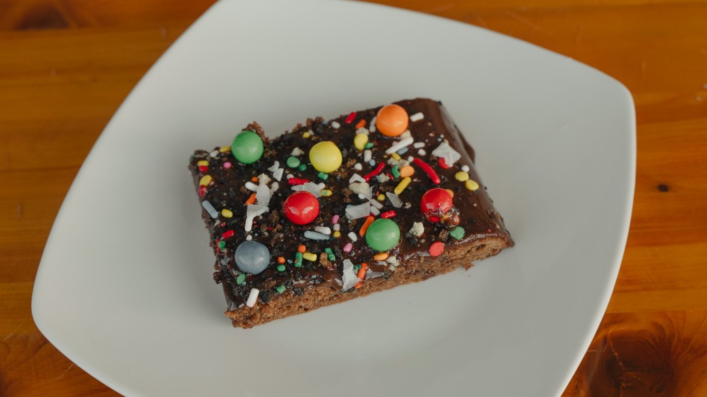 Chocolate brownie bar with colorful toppings on a plate